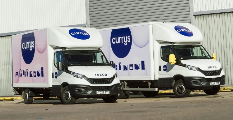 Two Currys-branded IVECO delivery vans parked outside a depot.